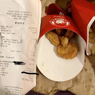 fried chicken in a paper bag and a receipt