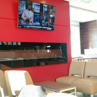 a television mounted on a red wall