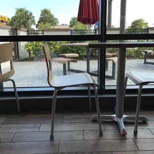 two chairs and a table in front of a window