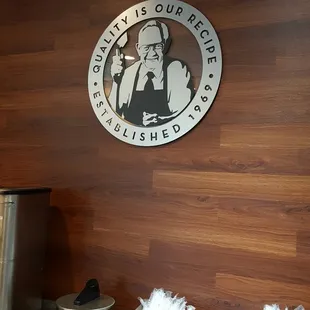 a wooden wall with a sign above it