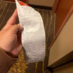 a person holding a receipt in their hand
