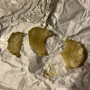 a half eaten apple on a piece of tin foil