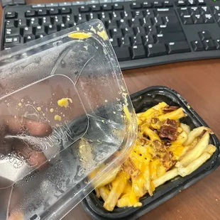 a plastic container of food on a desk