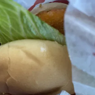 a hamburger with lettuce in a wrapper