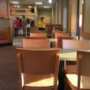 the inside of a restaurant with tables and chairs