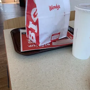 a cup of coffee and a bag of fries