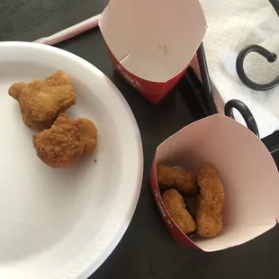 a plate of fried chicken nuggies and a paper plate of fried chicken nuggies