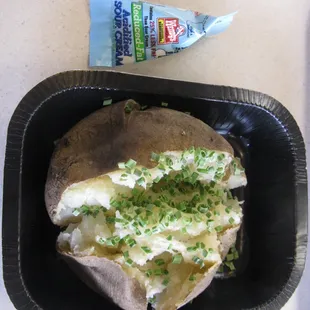 One baked potato with chives and sour cream. $1.39