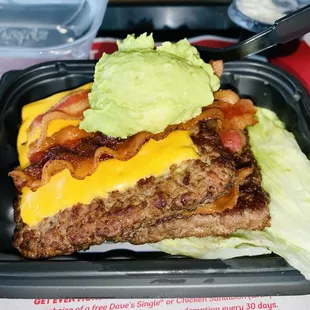 a burger with lettuce and bacon