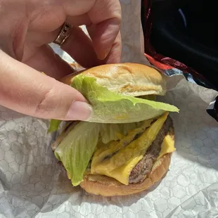 a hamburger with lettuce and cheese