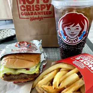 a burger and fries with a drink