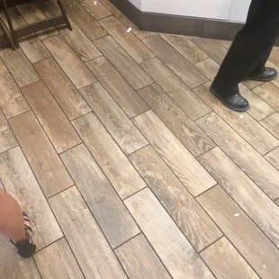 a woman standing on a wooden floor