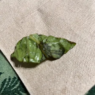 a leaf on a napkin