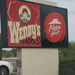 a sign for wendy&apos;s pizza hut