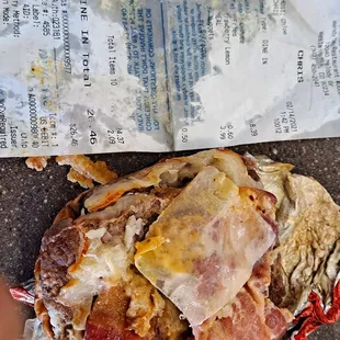 Proof of purchase receipt with another view of the pretzel pub garbage burger with wax paper choke hazard still inside