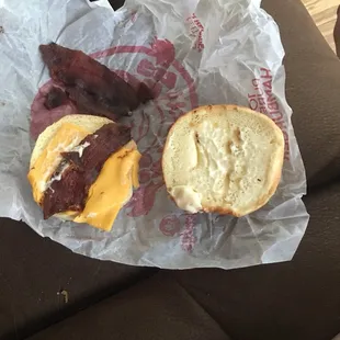 a bacon and cheese sandwich on a piece of wax paper