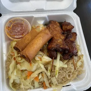 Chicken skewers with pancit and lumpia