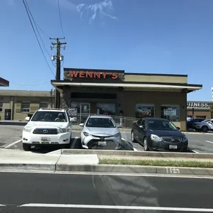 cars parked in front of a restaurant