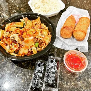 a bowl of noodles, a bowl of chicken, a bowl of rice, and a bowl of chicken nuggies