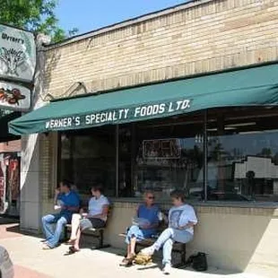 people sitting outside a store