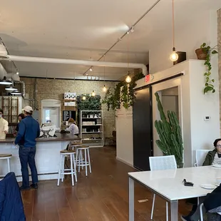 a man sitting at a table in a cafe