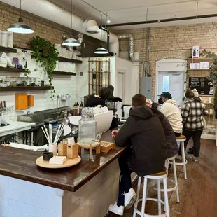 people sitting at a counter in a coffee shop