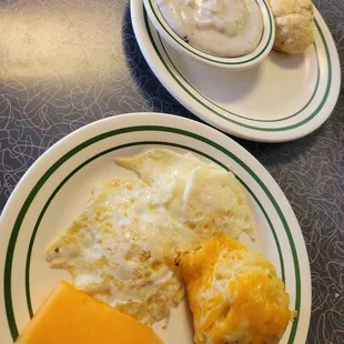 Two eggs with side of hashbrown casserole &amp; biscuit w/gravy.
