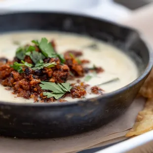 a bowl of soup and tortillas