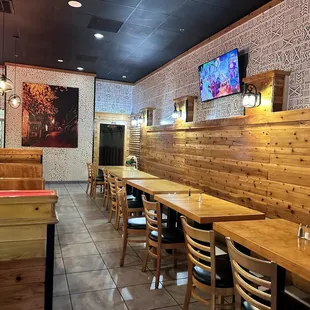 a dining area with wooden tables and chairs