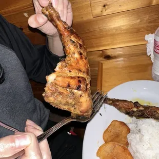 a person holding a fork over a plate of food