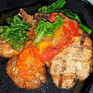 Bone-In Pork Chop, roasted Yukon potatoes, cherry tomato compote.