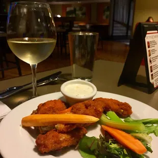 a plate of food and a glass of wine