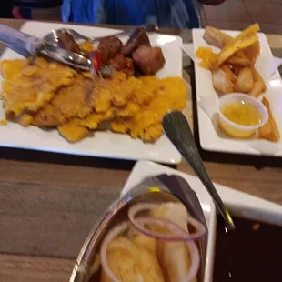 My steak with yellow rice and beans yuca MOJO and tontones and pork bites