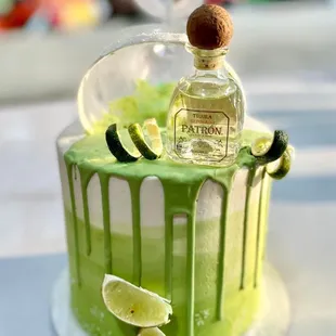 a lime cake with a bottle of tequila