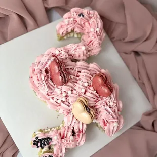 a pink cake with pink icing