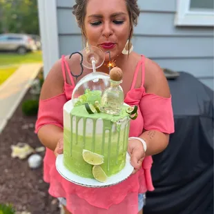 a woman holding a cake