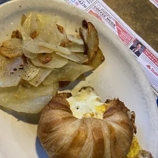 Home fries with sausage egg and cheese on a Croissant Sandwich