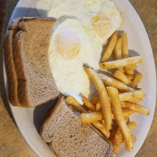 2 eggs over easy, wheat toast and fries.