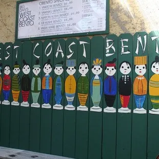 a group of people painted on a fence