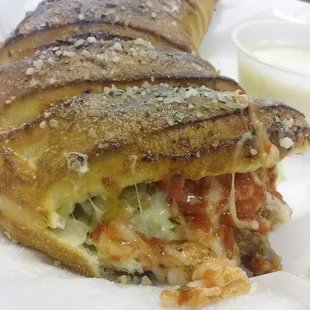 Small beef sausage and eggplant calzone (with one bite missing).