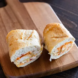 two sandwiches on a cutting board