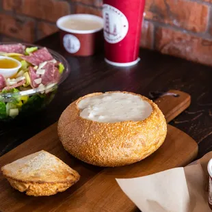 a bowl of sourdought and a sandwich on a cutting board