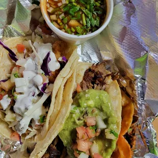 Fish, Pork, and Birria tacos with soup for dipping