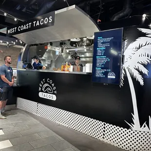 a man standing in front of a food truck