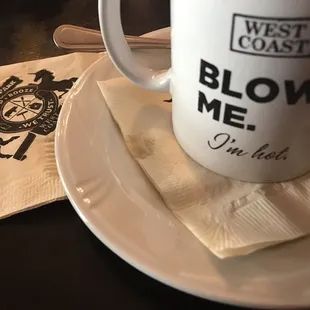 a coffee cup and napkin on a table