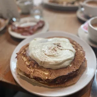 Cinnamons roll pancakes and a side of bacon