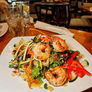 a plate of salad with shrimp