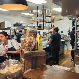 a man and a woman working in a kitchen