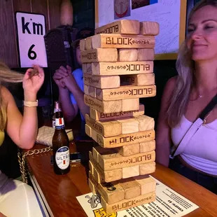 two women playing a game of giant blocks