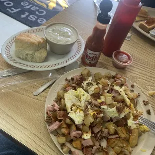 a plate of hash browns with bacon and eggs